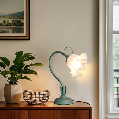 Flower desk lamp with vintage sage green finish on a mid-century credenza