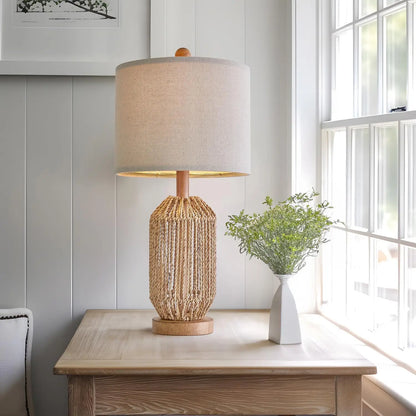 boho rattan lamp on end table in bright airy living room