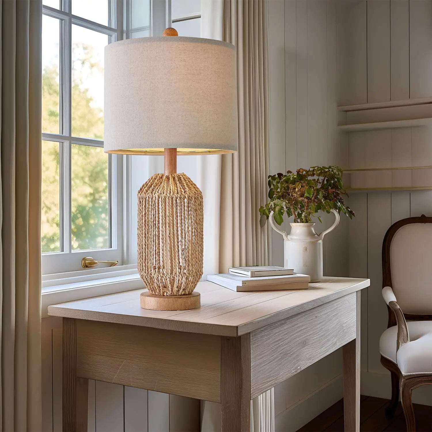 vintage rattan table lamp next to eucalyptus vase on farmhouse console