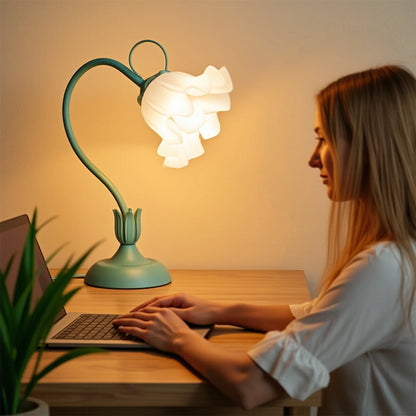Blooming flower lamp illuminating a desk workspace at night