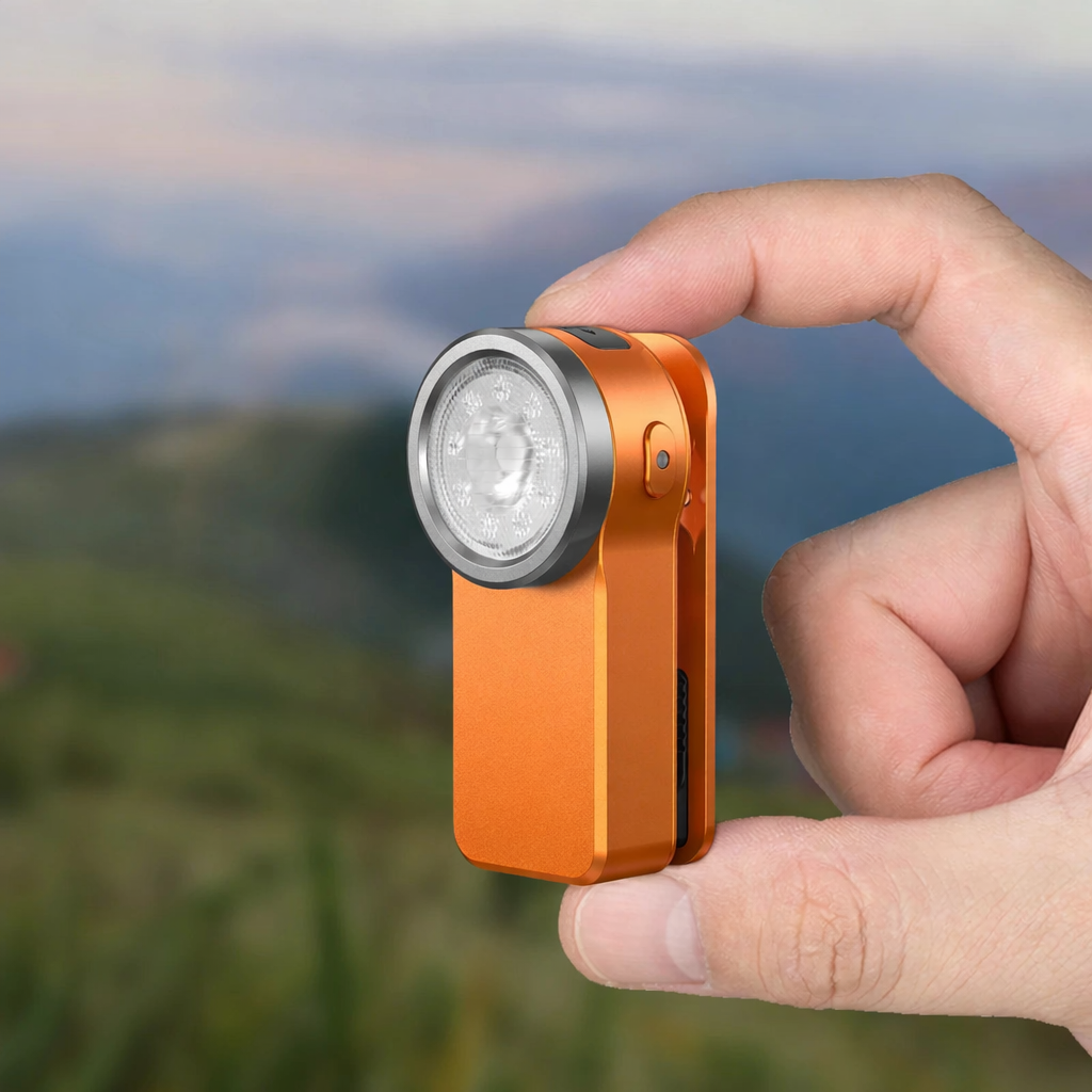 mini edc flashlight held between fingers showing pocket size