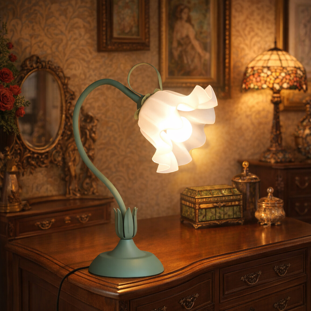 Vintage flower table lamp with sage green stem and glass shade on wooden dresser