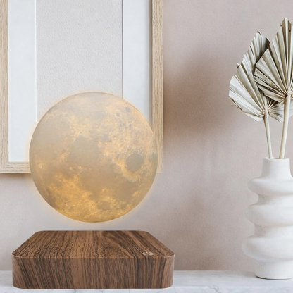 levitating moon lamp floating above wooden base in modern room with dried palm leaf decor
