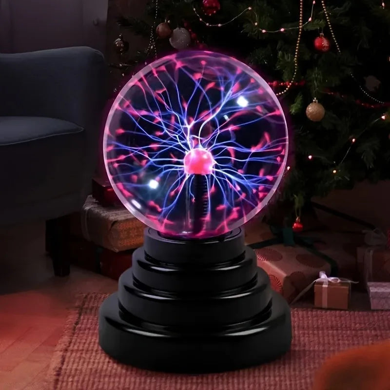 tesla ball as holiday gift under christmas tree with warm lighting